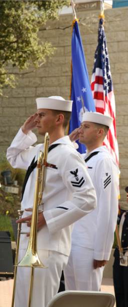 Photo: Two military band musicians salute