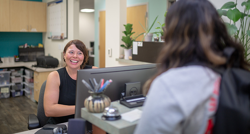 photo: student getting help at front desk