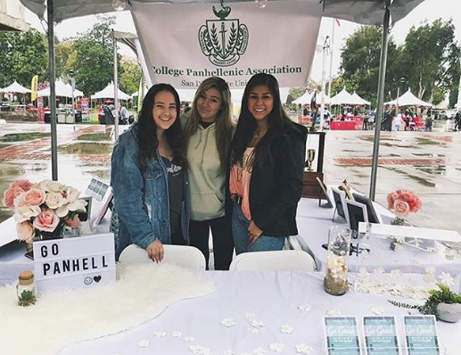 Three members of the executive board of the College Panhellenic Association at their table during Explore SDSU 2018 