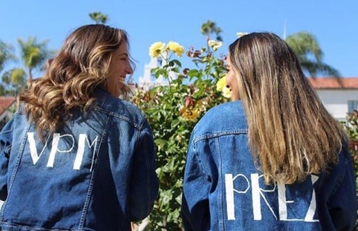 Vice President of Membership and President wearing jean jackets with their titles, backs to camera