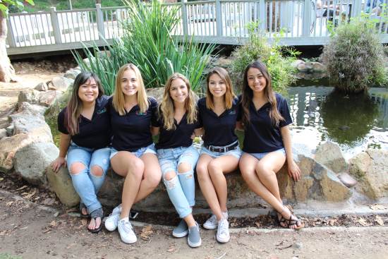 SISSTER students sitting by the turtle pond