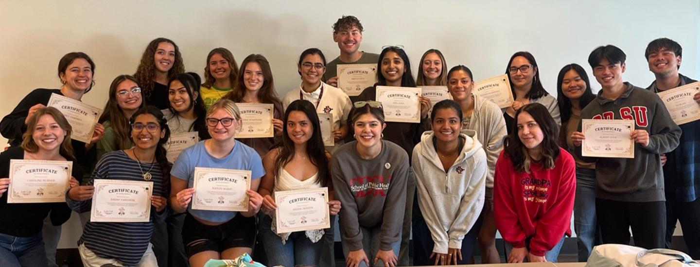 Group of people holding certificates