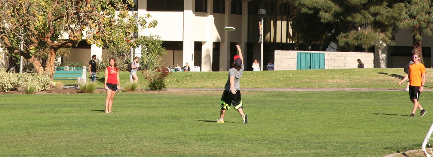 Students playing frisbee.