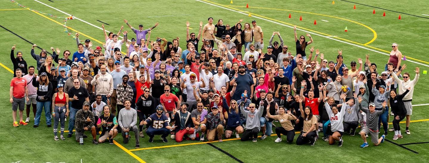 Big group of people cheering on a field
