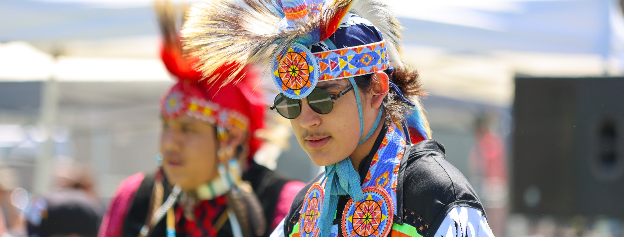 Person dressed in cultural clothing for Pow Wow event.