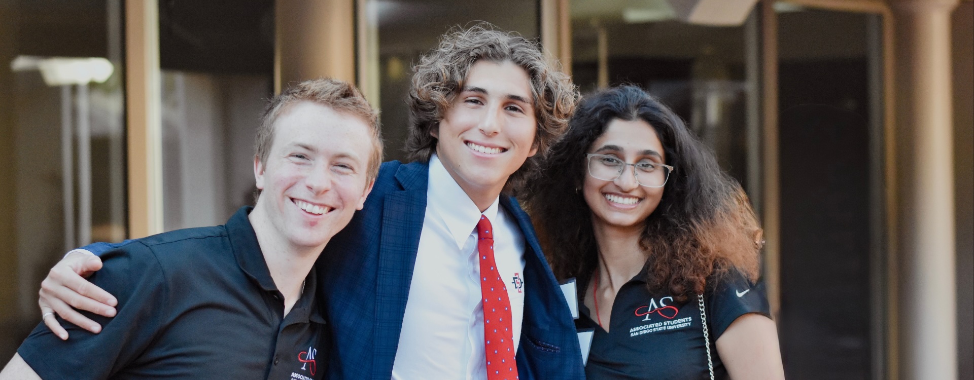 group of students smiling and sidehugging