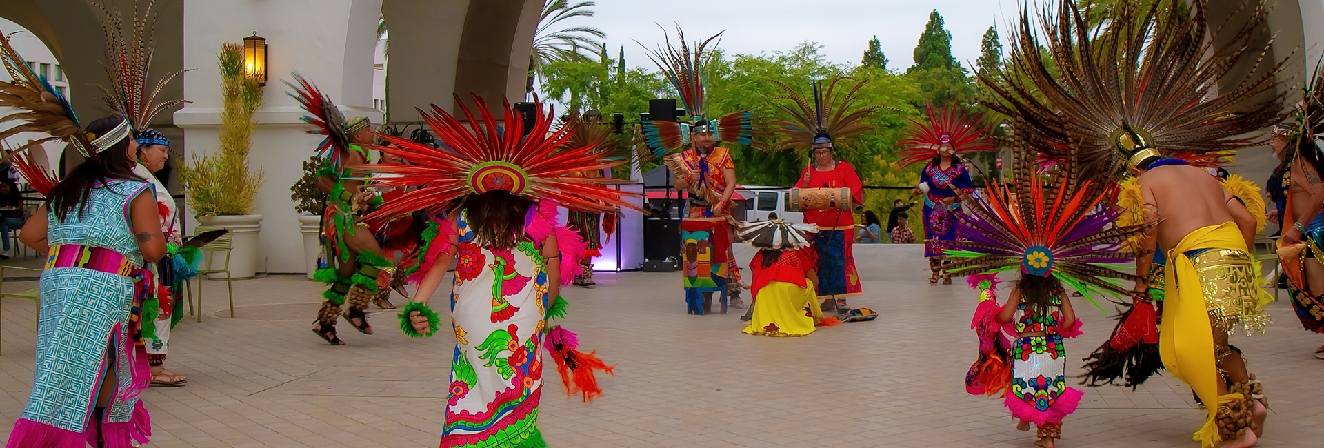 people dancing at the Conrad Prebys Aztec Student Union. drummers in the back.