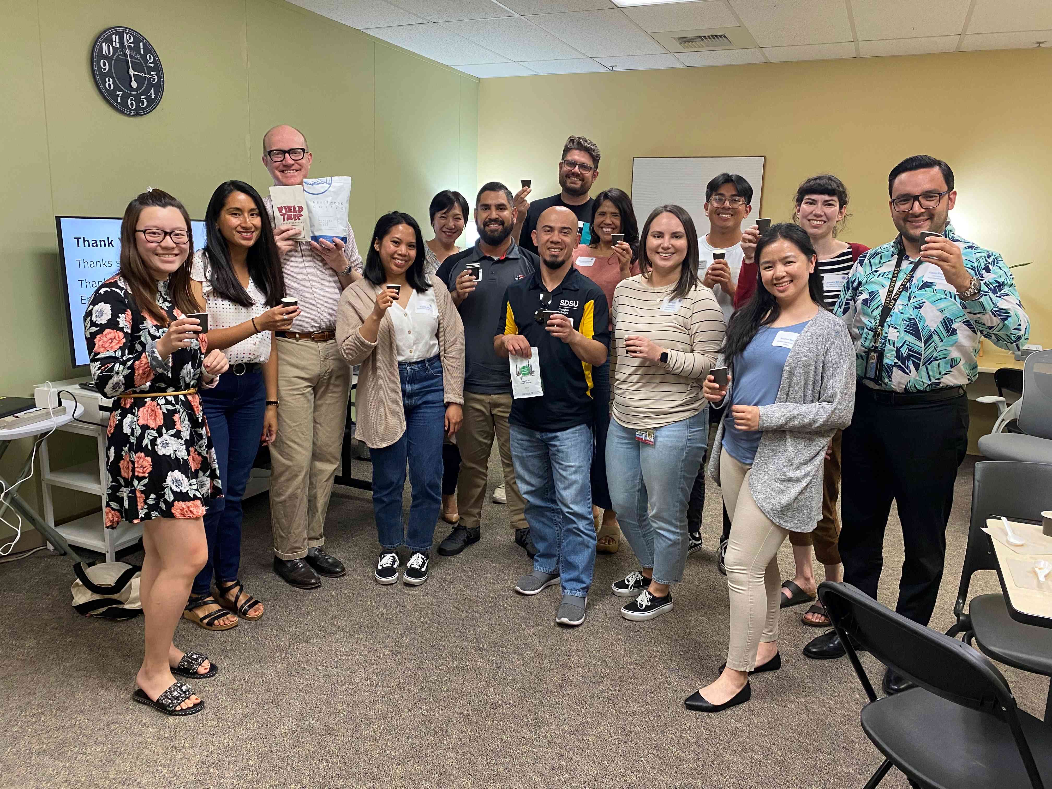 group photo of staff holding coffee tasting cups