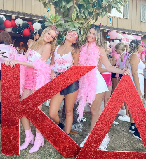Kappa Delta members celebrate on bid day, dressed up in a "Pink Ladies" theme from the movie Grease.