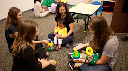 parents at daycare circle with children