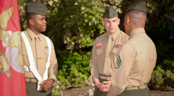 Marines talking-holding US flag